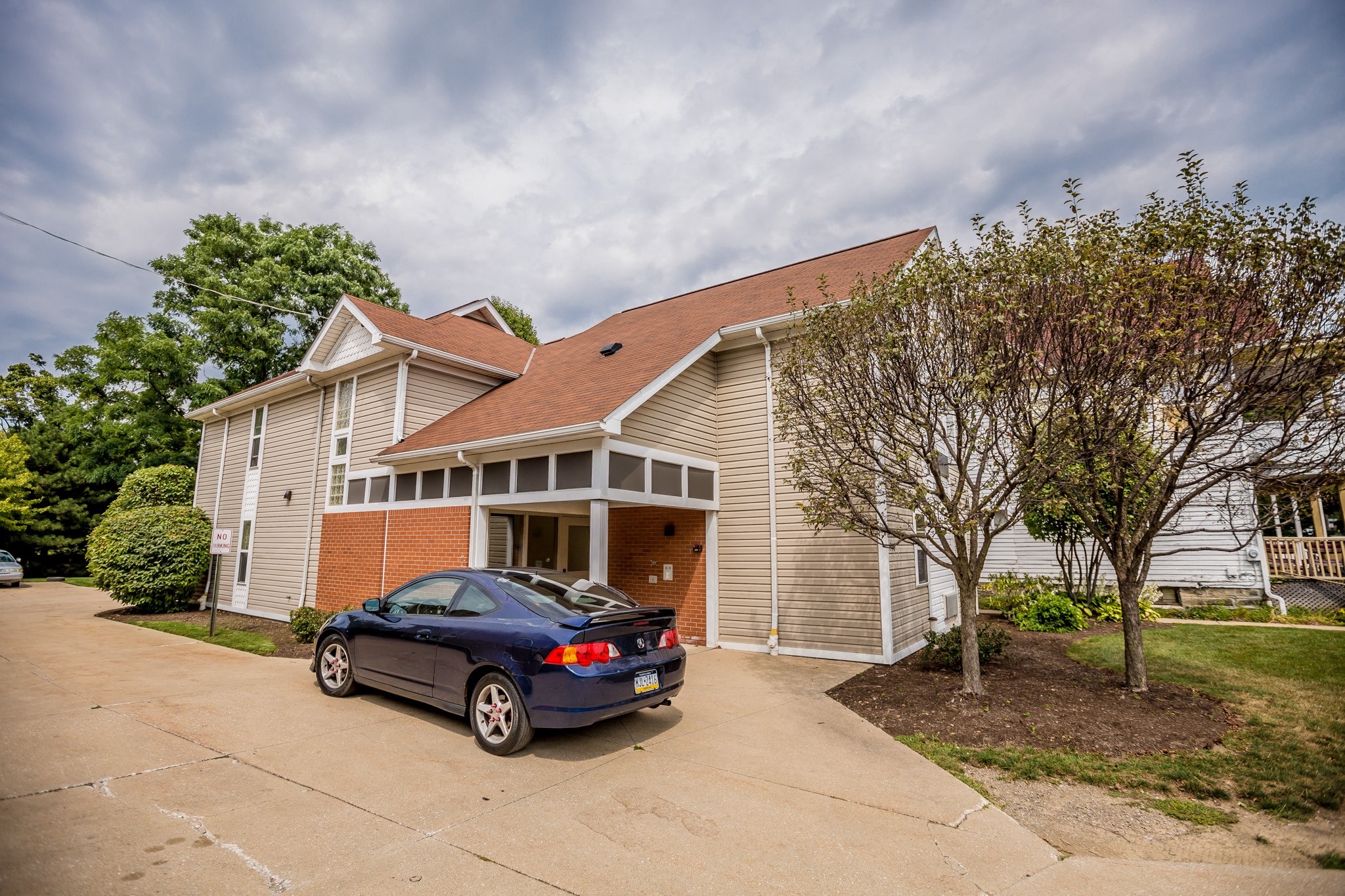the front of a house with a car parked in the driveway